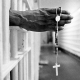 An inmate with a jail issued cross inside the segregation unit at Pitchess Honor Rancho, one of the ten different units that comprise the sprawling Los Angeles County Jail system which houses 21,000 inmates, the world's largest jail population.