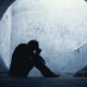 Desperate,Businessman,In,Silhouette,Lying,On,The,Ground,And,Holding